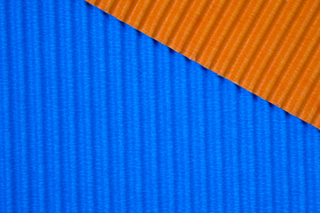 Blue and orange corrugated paper texture, use for background. vivid colour with copy space for add...