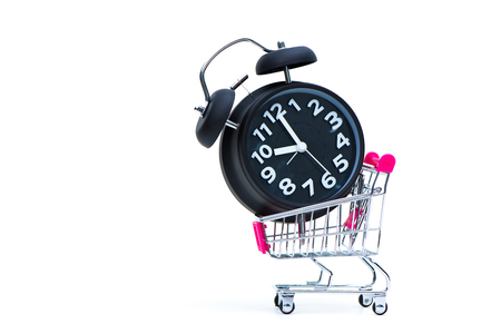 Black vintage alarm clock and shopping cart or supermarket trolley isolated on white background, business finance shopping concept, wake up time.の写真素材