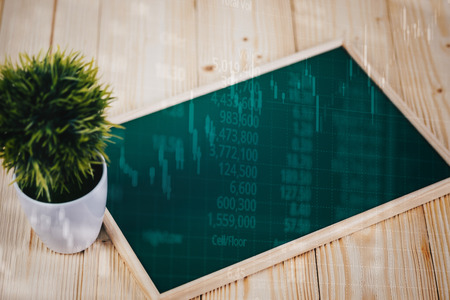 Double exposure of blank green chalkborad and little tree on wooden table with stock market screen chart board and candle stick for financial business and investor analysis concept idea.の写真素材