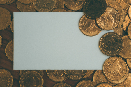 Blank business card or name card with copy space for add text name address and company logo, stack of coin on working table, financial company concept idea.の写真素材