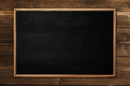 Abstract blackboard or chalkboard with frame on wooden background. empty space for add text.の写真素材