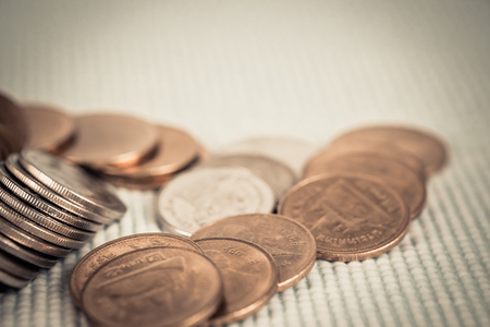 Double exposure Stack of coin with financial graph over city and office building background,...
