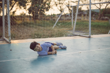Outdoor portrait of a happy Asian student kid in school uniform smiling with copy space for add text or word.の写真素材