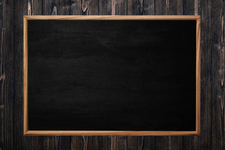 Abstract blackboard or chalkboard with frame on wooden background. empty space for add text.の写真素材