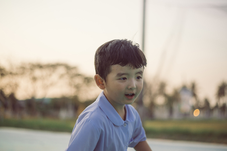 Outdoor portrait of a happy Asian student kid in school uniform smiling with copy space for add text or word.の写真素材