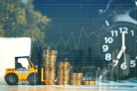 Double exposure miniature mini forklift truck with coin stack on working table on city background for business financial conceptの写真素材