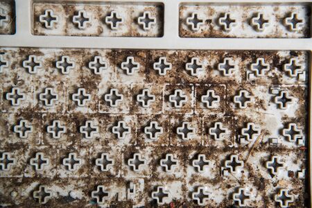 Dirty stain under the keypad of keyboard computer, unsightly and unclean equipment in office.