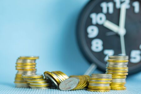 Stacks of coin with alarm clock copy space, time for savings money concept, banking and business idea. shallow focus.の写真素材