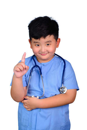 Smiling Asian boy in blue medical uniform doctor costume with stethoscope isolated on white.の写真素材