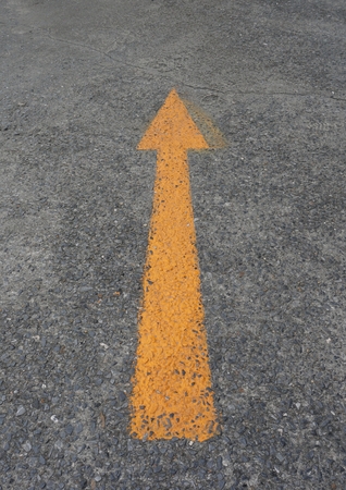 yellow arrow on asphalt groundの写真素材