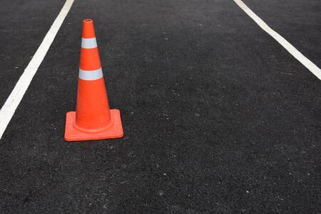 Traffic cone on the floor to remind the no parking blur backgroundの写真素材