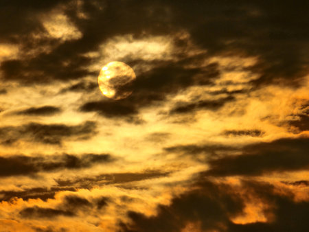 The moon and the clouds in the sky at sunset, closeup of photo