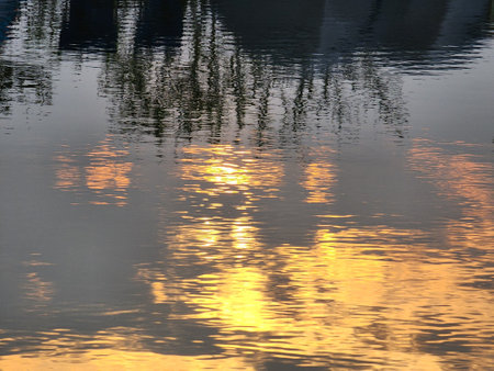 Reflection of the sunset on the water surface of the river.