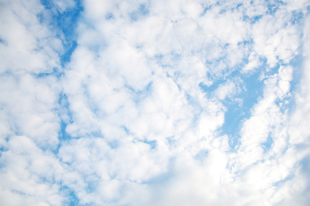 blue sky with white fluffy clouds backgroundの写真素材