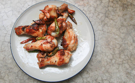 fried chicken with garlic and chilli in dish on concrete backgroundの写真素材