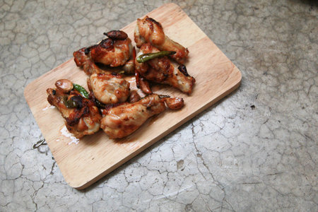 fried chicken with garlic and chilli on trencherの写真素材