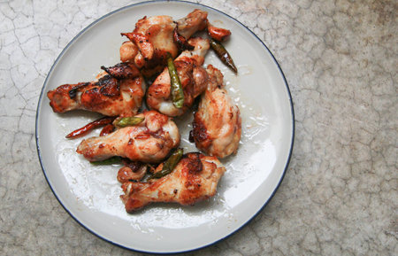 fried chicken with garlic and chilli in dish on concrete backgroundの写真素材