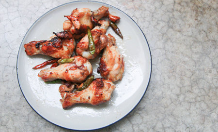 fried chicken with garlic and chilli in dish on concrete backgroundの写真素材