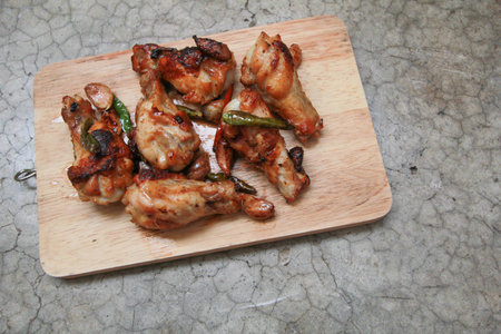 fried chicken with garlic and chilli on trencherの写真素材