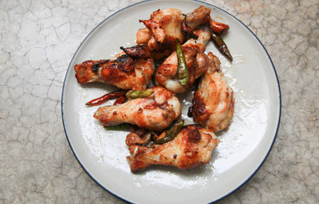 fried chicken with garlic and chilli in dish on concrete backgroundの写真素材