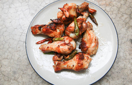 fried chicken with garlic and chilli in dish on concrete backgroundの写真素材