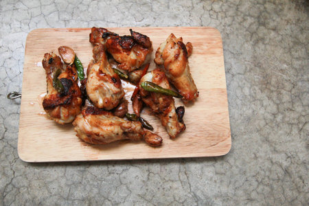 fried chicken with garlic and chilli on trencherの写真素材