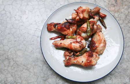 fried chicken with garlic and chilli in dish on concrete backgroundの写真素材
