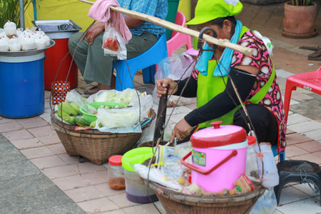 spicy mango mango - the woman cooking Som Tum for selling at market in khonkaen - Som Tum or papaya salad is traditional Thai food - thailand street foodのeditorial素材