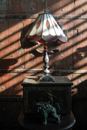 old lamp classic with light rays pass through the blinds in a dark roomの写真素材