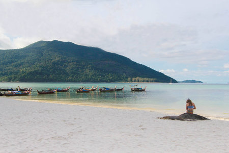 mermaid on the beach with Longtail boat and beautiful ocean with blue sky of Koh Lipe island, Thailandの写真素材