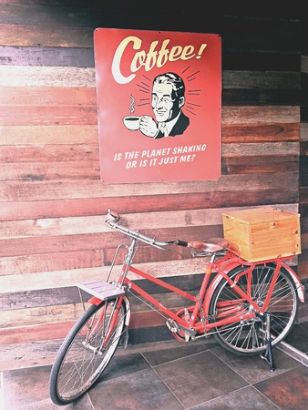 Red bicycle in front of a cafeの素材