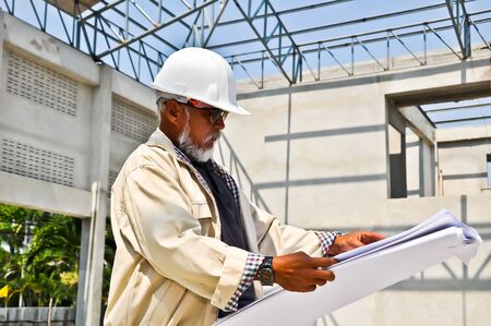   builder inspector worker checking a construction site works  の写真素材