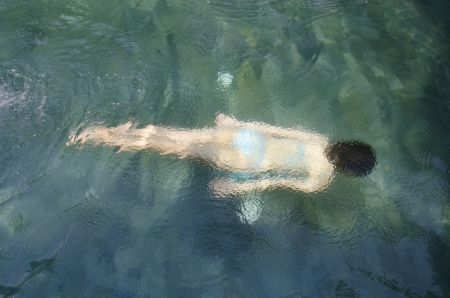 young asian girl is diving in the poolの写真素材