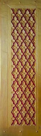 Thai temple window decorated with  gold and redの写真素材