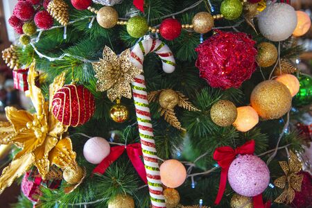 Christmas  tree decorate with balls gifts, candy and lightsの写真素材