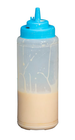 Condensed milk bottle with fly, isolated on white backgroundの写真素材