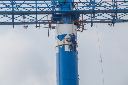 Workers working in high steel welding without safety equipment in Thailand の写真素材