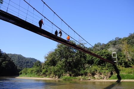 People walk across the rope bridge, north Thailand shot1の写真素材