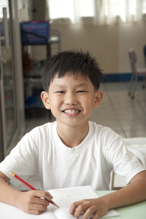 The Asian boy smile in classroomの写真素材