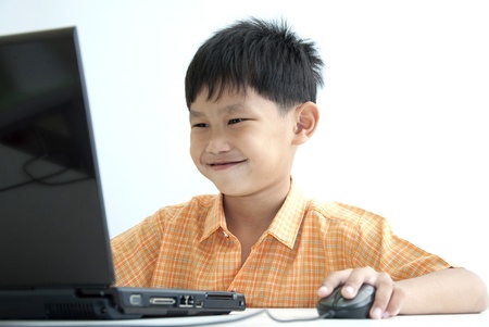 Asian boy using computer laptop の写真素材