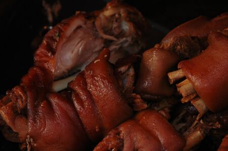 red pork legs in brown stew soup of spicesの写真素材