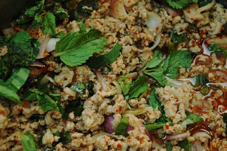 spicy minced checken salad with chilli and basil leavesの写真素材