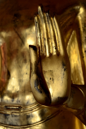 One Hand of Golden Buddha Image in the gesture of calming the ocean at Wat Pho. Bangkok.の素材