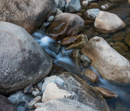 Water flowing over the rocksの写真素材