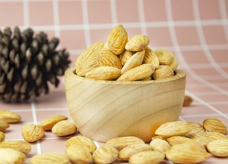 Delicious almonds in a bright, beautiful cupの写真素材