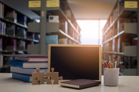 Education Concept, book, blackboard, pencil and notebook on table in library.の写真素材