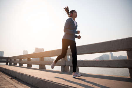 Young girl running and exercising in city. lifestyle concept.の写真素材