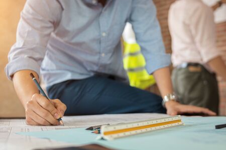 Civil engineer sketch the drawing construction building on the deskの写真素材