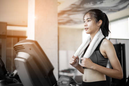 Young woman doing exercise workout treadmill at gym.の写真素材