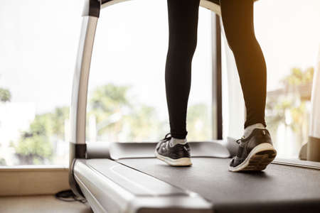Close up legs woman doing exercise workout treadmill at gym.の写真素材